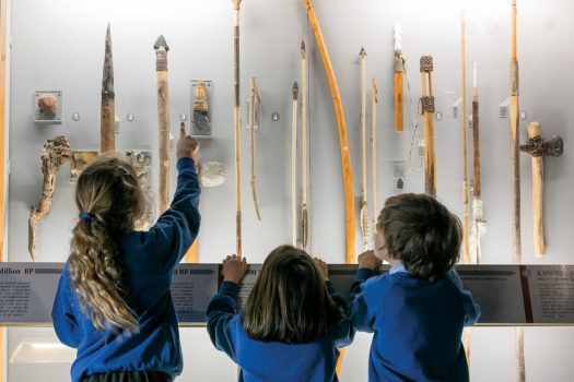 Children learning about pre-historic weapons at Cheddar Gorge Museum